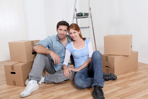 Professional movers handling furniture in a Belsize Park flat