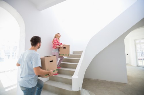 Careful unpacking of household items in a Belsize Park flat