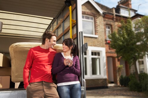 Movers navigating stairs in a Belsize Park flat move